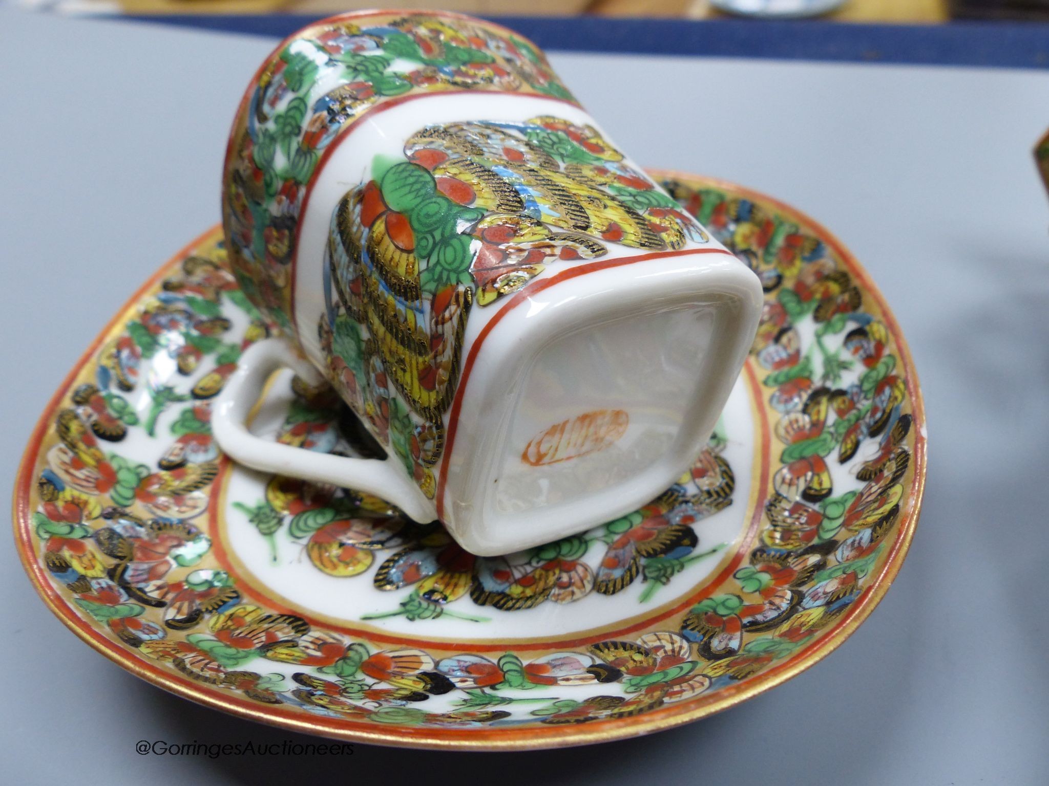 A Chinese famille rose small vase and two cups and saucers